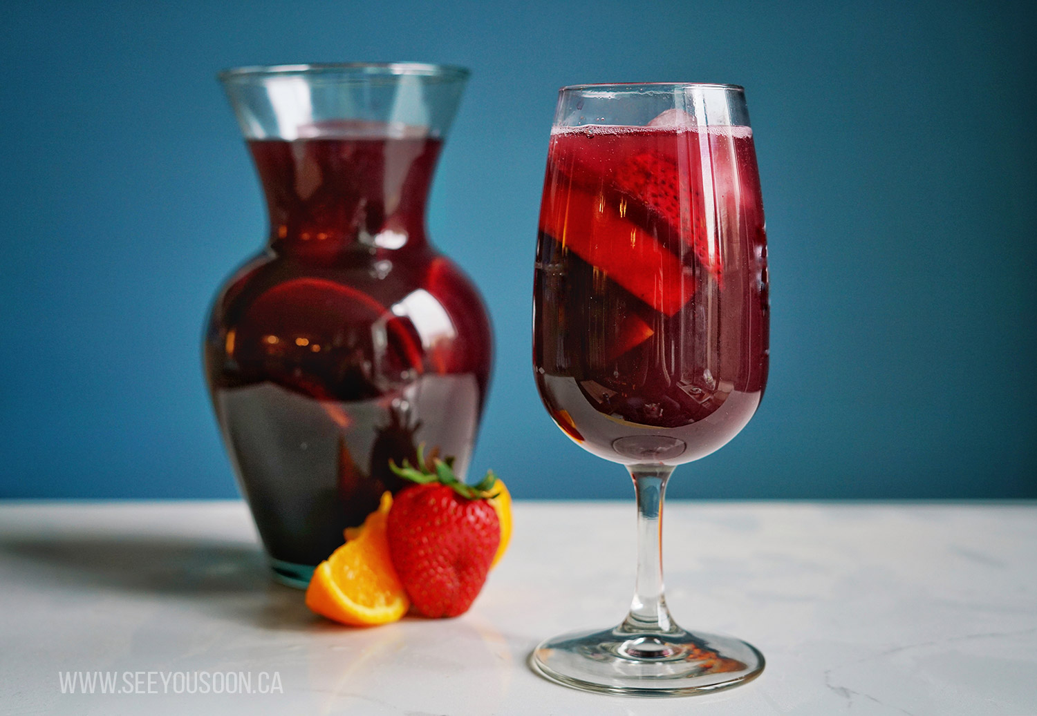Sangria in a glass and a pitcher. Travel inspired cocktails.